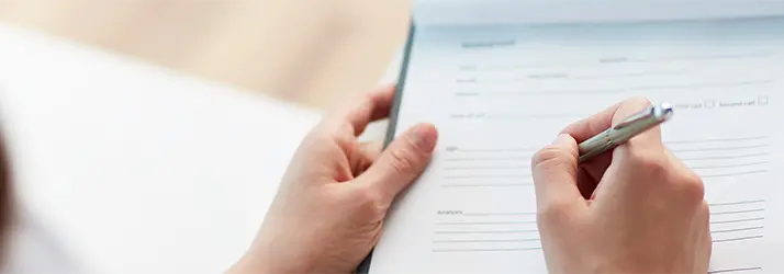 Chiropractic Bakersfield CA Paperwork Patient filling out paperwork.